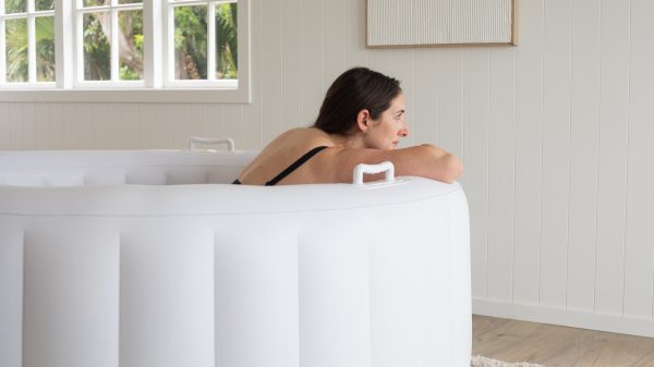 Bloom Birth Pool - woman relaxing in pool resting on the edge